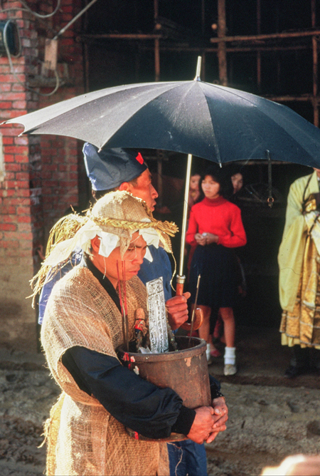 The eldest son holding the rice